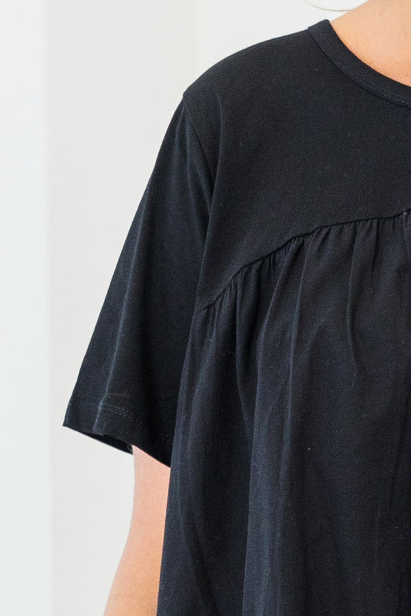 Chic Soul plus size clothing, black short sleeve flowy top with round neckline with cinch along chest with ruffle stripe detail along bottom