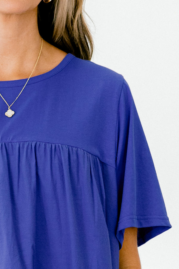Chic Soul Plus size clothing, blue short sleeve blouse with ruffle detailing the bottom of the shirt 
