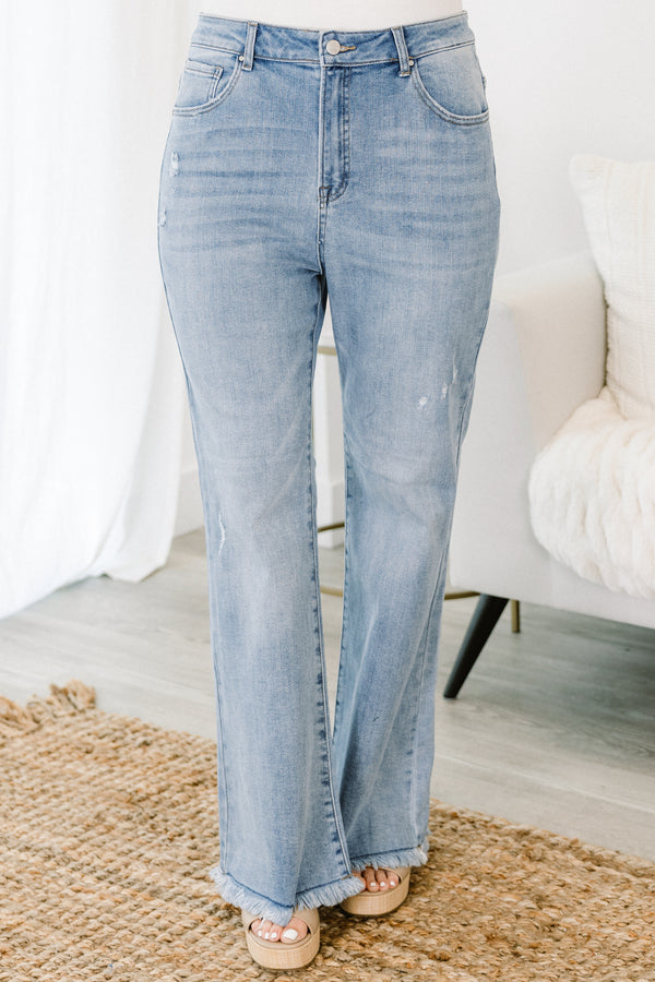 Chic Soul plus size clothing, high-waisted light wash slim-fitting bootcut blue jeans with subtle fraying along the hem and subtle distress on the legs