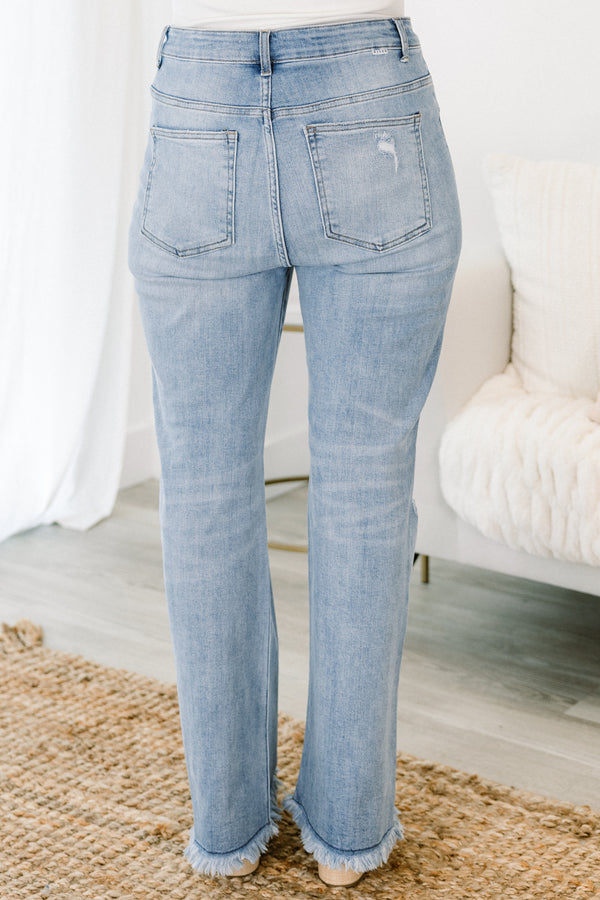 Chic Soul plus size clothing, high-waisted light wash slim-fitting bootcut blue jeans with subtle fraying along the hem and subtle distress on the legs