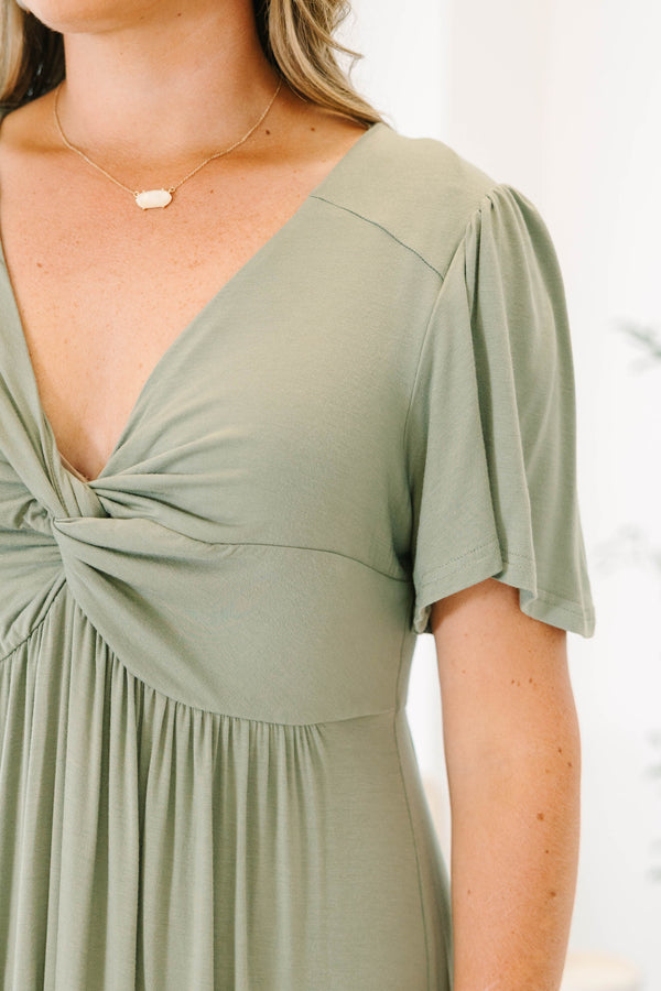 Plus Size olive maxi dress with a twist-front V-neckline, flutter sleeves, and a ruffled hem.