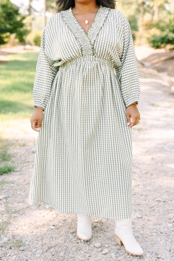 Plus size green and white plaid midi dress with a smocked waist, ruffle neckline, and flowy fit.