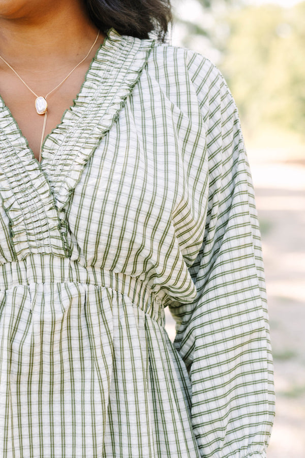 Plus size green and white plaid midi dress with a smocked waist, ruffle neckline, and flowy fit.