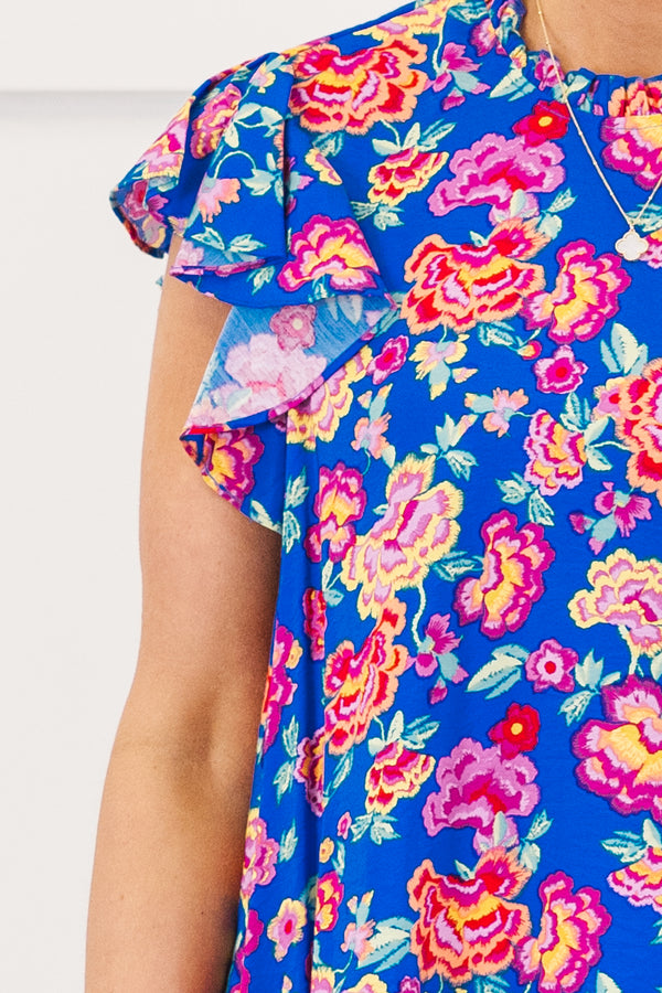 Chic Soul plus size clothing, royal blue short sleeve top with ruffle round neckline with flutter ruffle sleeves with large multicolor pink floral print
