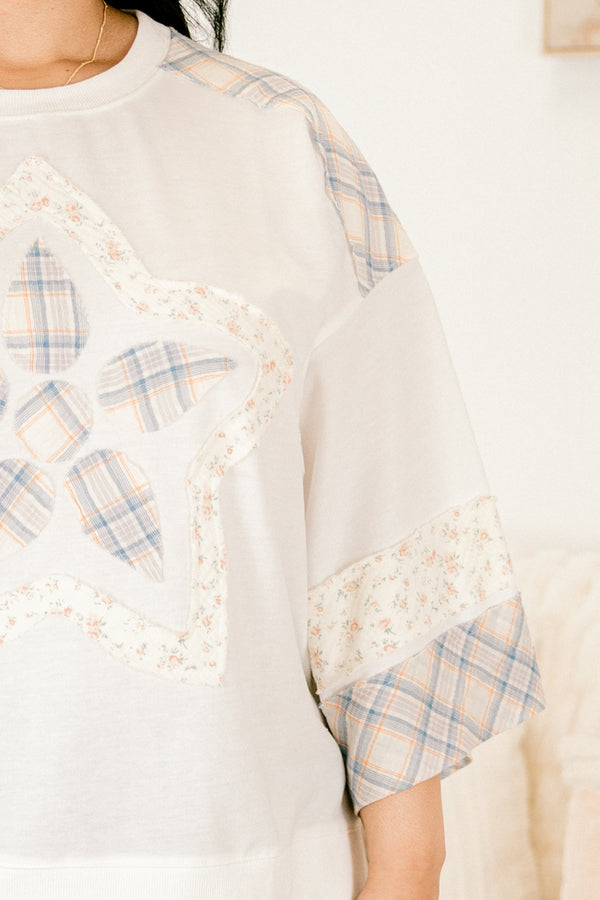 Plus Size white boho top with patchwork star design, plaid accents, and drop shoulder sleeves.