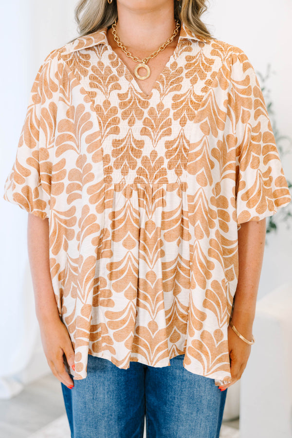 Plus Size tan and white patterned babydoll top with short sleeves and a smocked V-neckline.