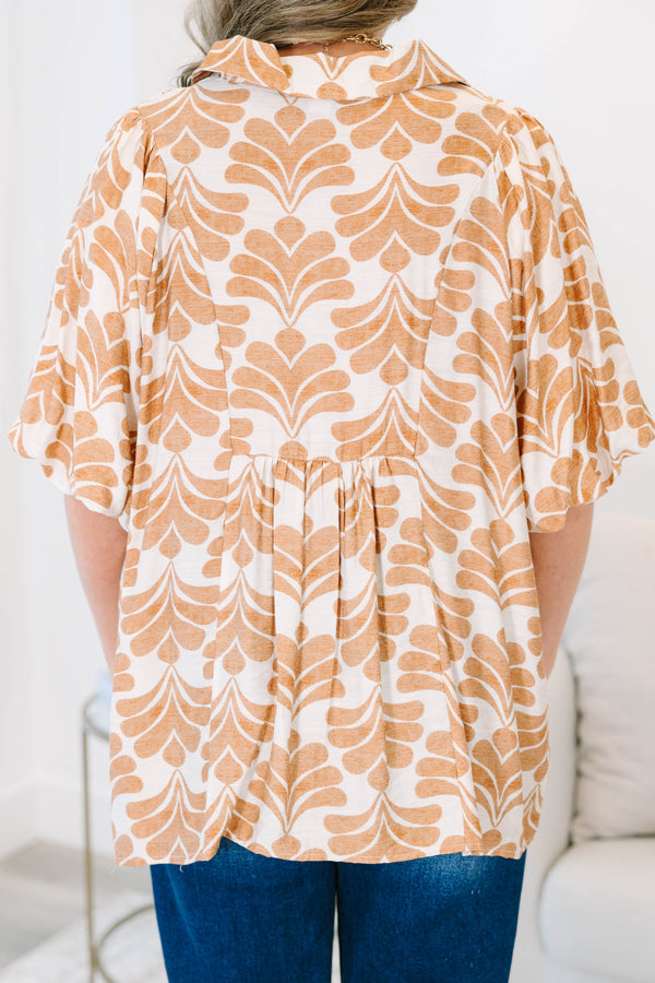 Plus Size tan and white patterned babydoll top with short sleeves and a smocked V-neckline.