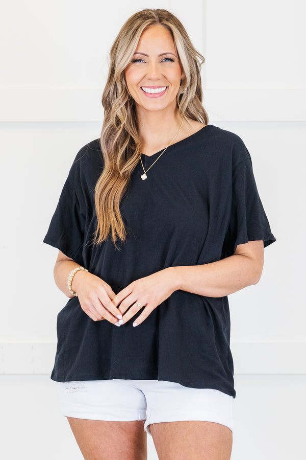 Plus Size black v-neck short sleeve cotton tee paired with white denim shorts.