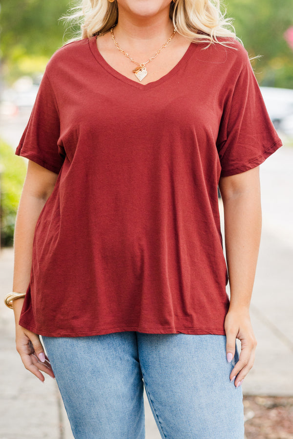 Plus Size dark rust short sleeve v-neck cotton tee paired with light wash denim jeans.