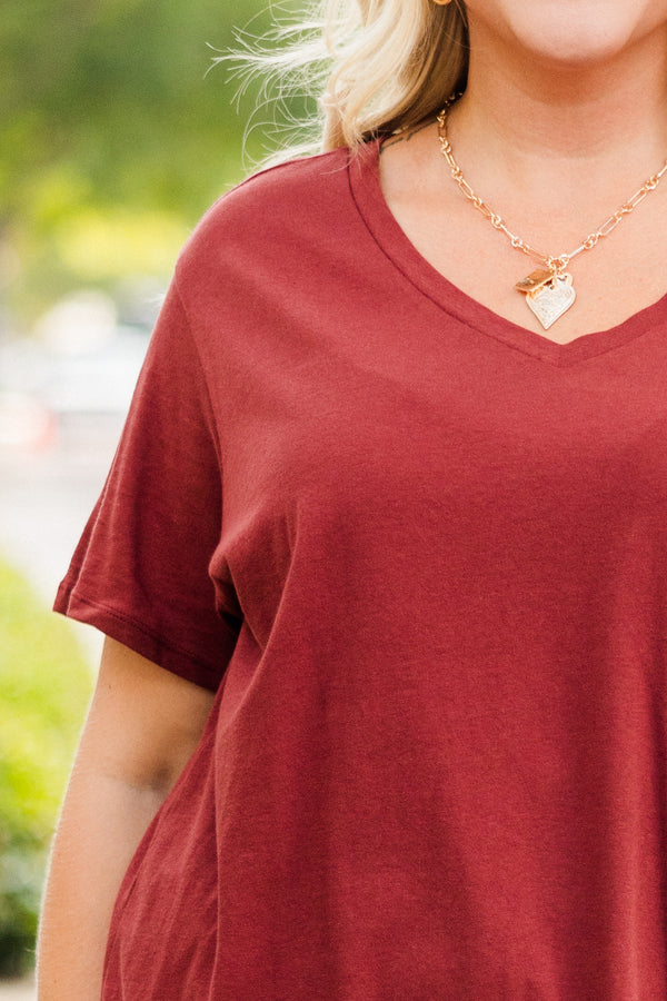 Plus Size dark rust short sleeve v-neck cotton tee paired with light wash denim jeans.