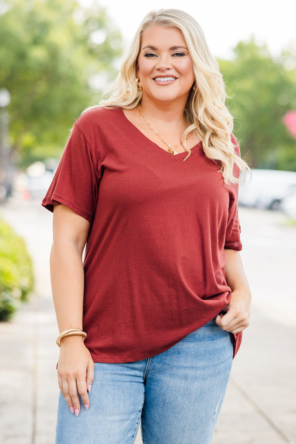 Plus Size dark rust short sleeve v-neck cotton tee paired with light wash denim jeans.