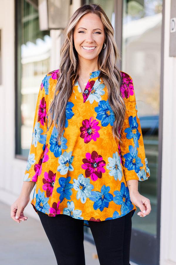 Chic soul plus size boutique, golden yellow floral top with magenta, deep blue, and light blue floral print, 3/4 quarter length sleeves, v-neck slit at the top