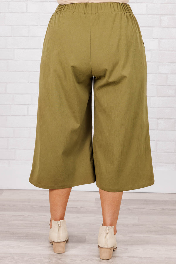 Plus Size olive green wide-leg cropped pants with an elastic waistband and four front buttons.