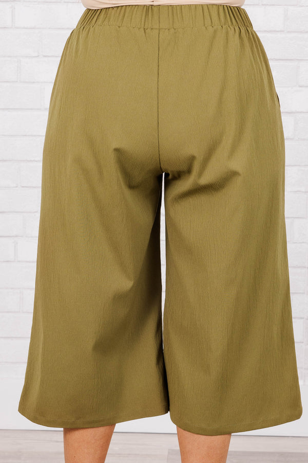 Plus Size olive green wide-leg cropped pants with an elastic waistband and four front buttons.