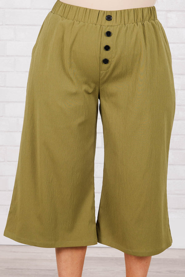 Plus Size olive green wide-leg cropped pants with an elastic waistband and four front buttons.