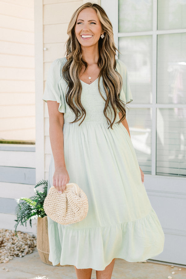 Plus Size sage green midi dress with a smocked bodice, flutter sleeves, and a tiered ruffle hem.