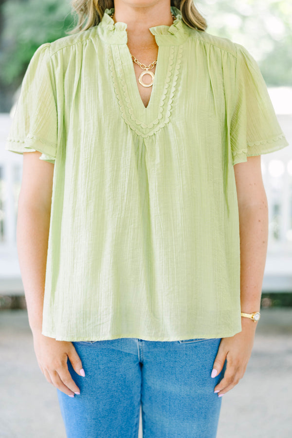 Plus Size light green textured top with a ruffled V-neckline, short flutter sleeves, and lace trim.
