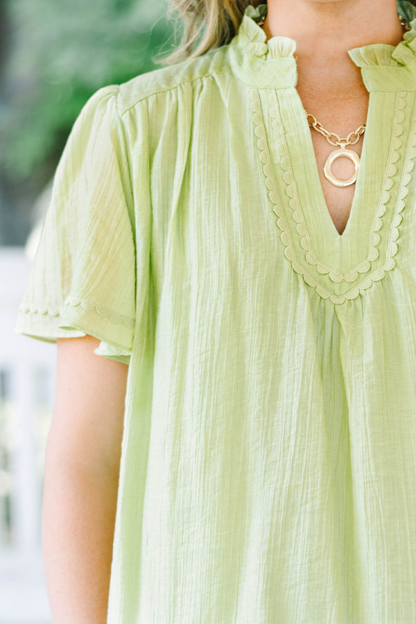 Plus Size light green textured top with a ruffled V-neckline, short flutter sleeves, and lace trim.