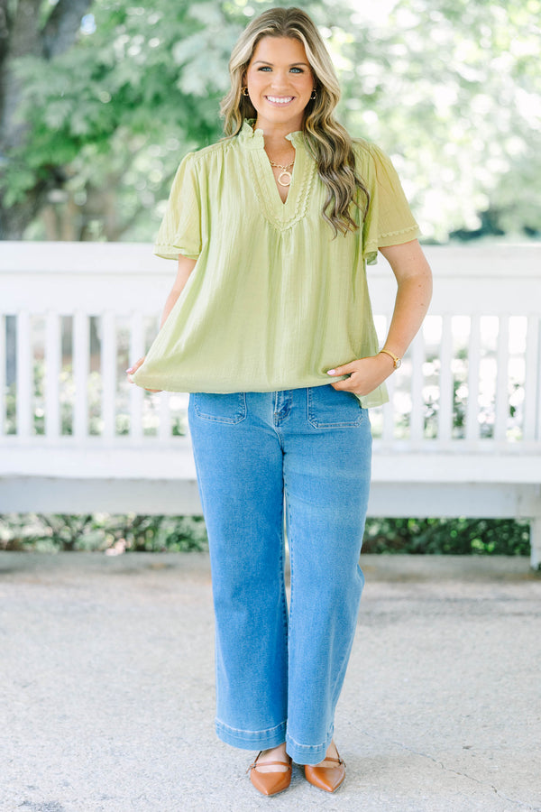 Plus Size light green textured top with a ruffled V-neckline, short flutter sleeves, and lace trim.