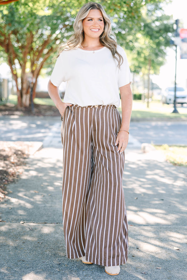 Plus size brown and white vertical stripe wide-leg pants in a flowy rayon fabric.