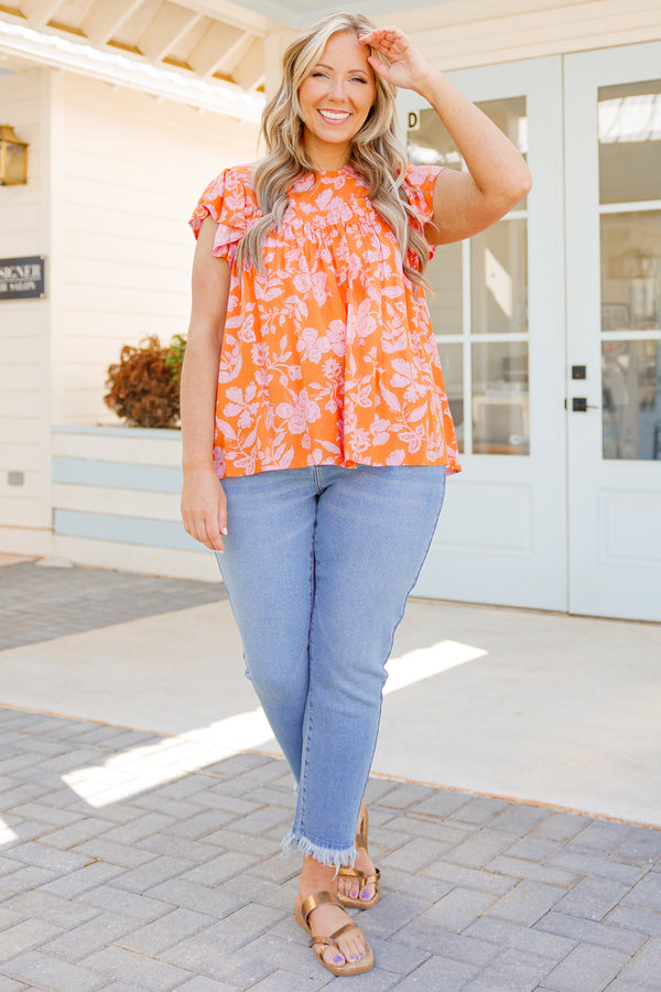 Chic Soul plus size clothing, orange flowy top with pink floral pattern and flutter sleeves