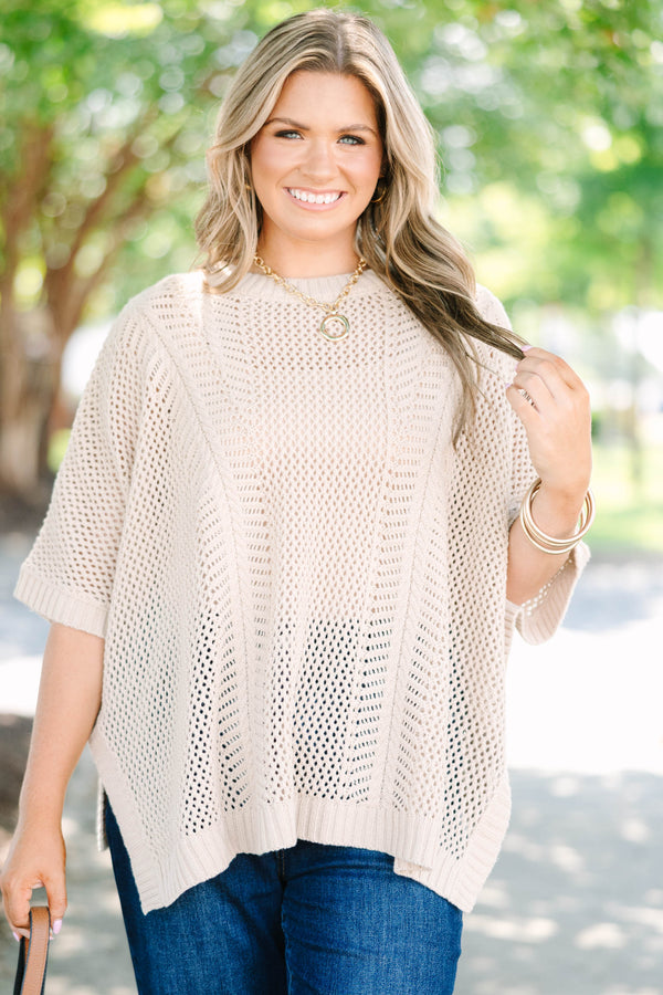 Plus size flowy oatmeal knit poncho sweater with a relaxed fit and textured stitch.