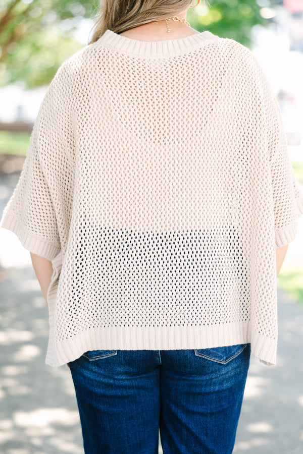 Plus size flowy oatmeal knit poncho sweater with a relaxed fit and textured stitch.