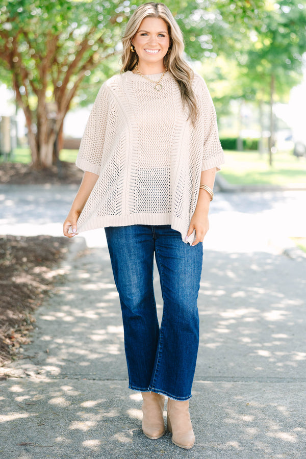 Plus size flowy oatmeal knit poncho sweater with a relaxed fit and textured stitch.