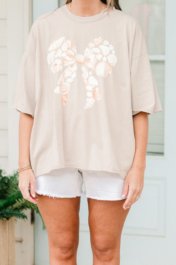 Chic Soul plus size clothing, short-sleeve stone tan drop-shoulder vintage wash tee with a high-scoop-neckline with a graphic of seashells in the shape of a bow