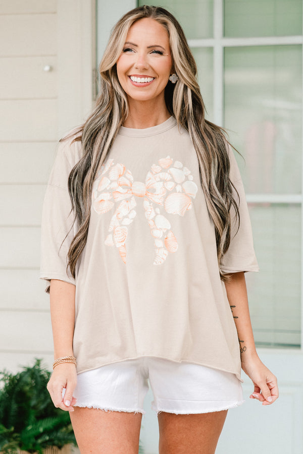 Chic Soul plus size clothing, short-sleeve stone tan drop-shoulder vintage wash tee with a high-scoop-neckline with a graphic of seashells in the shape of a bow