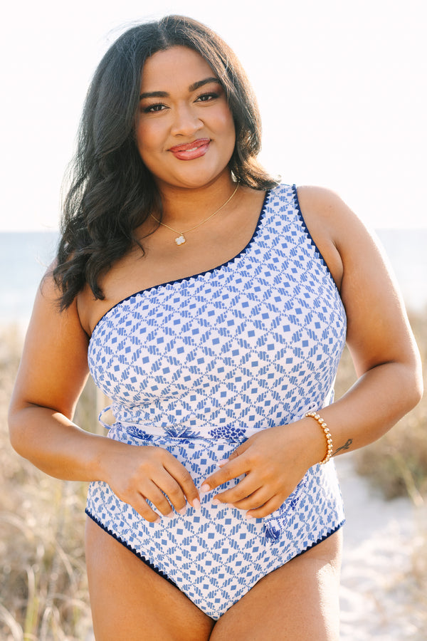 Chic Soul plus size clothing, one piece with one shoulder that has a blue abstract print and royal blue piping as well as a detachable belt that has a floral pattern  