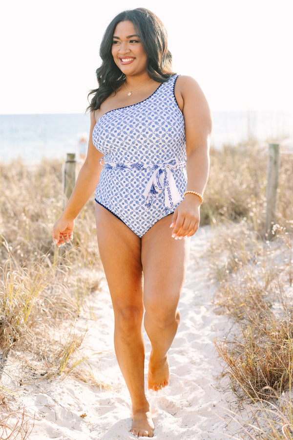 Chic Soul plus size clothing, one piece with one shoulder that has a blue abstract print and royal blue piping as well as a detachable belt that has a floral pattern  