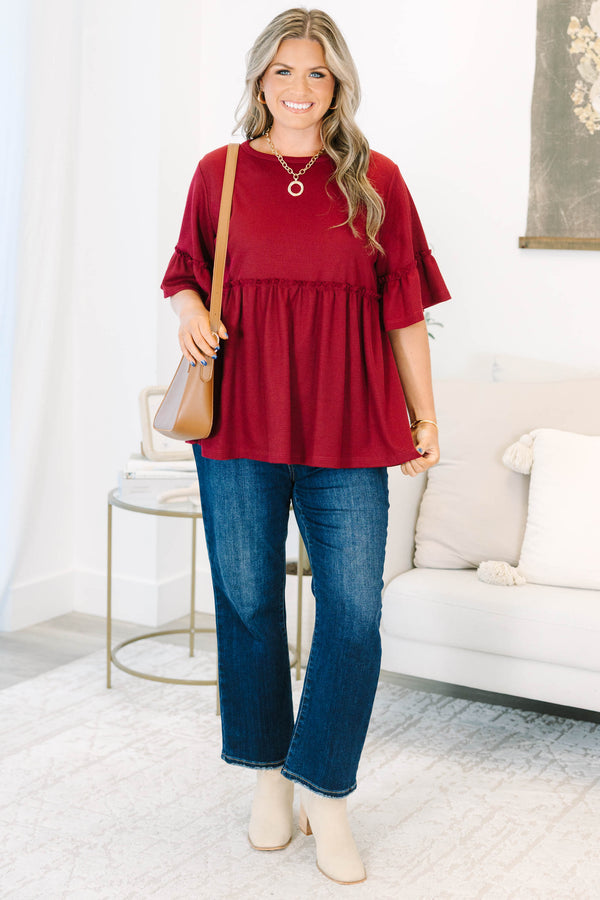 Plus Size burgundy waffle knit tunic with a round neck, ruffle sleeves, and a tiered babydoll fit.