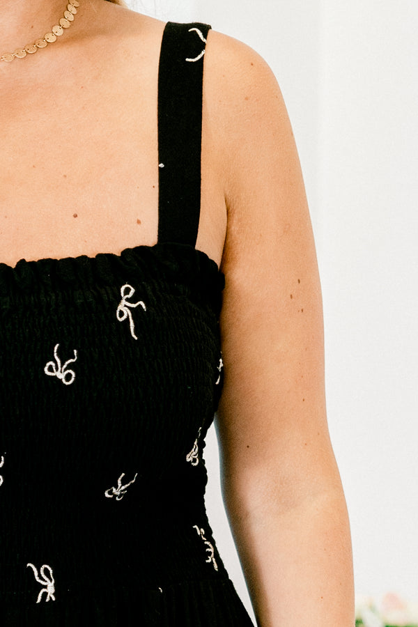 Chic Soul plus size clothing, black adjustable shoulder straps jumpsuit with dainty white bow pattern and pockets