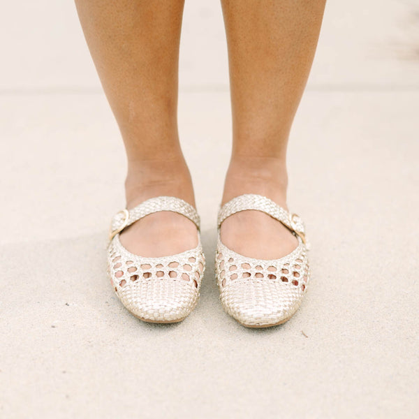 Chic Soul plus size clothing, gold woven close toed flats with a strap going across that top of the foot that had a buckle 