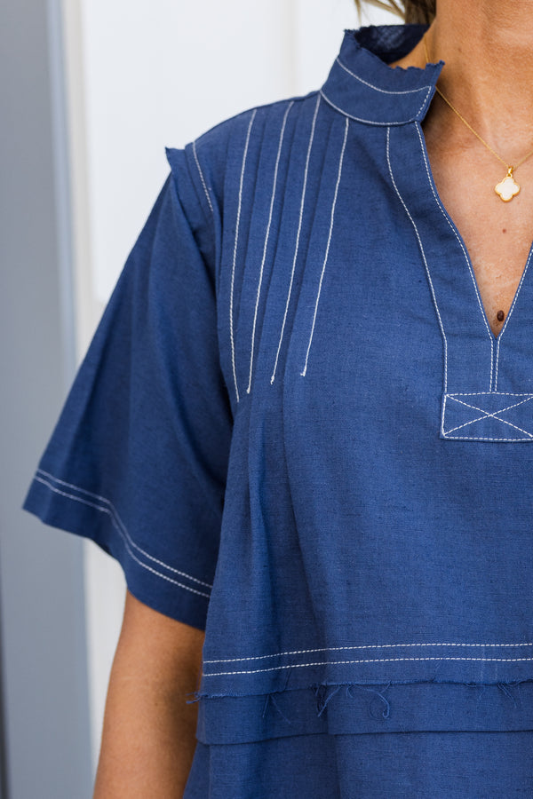 Chic soul plus size clothing, navy baby doll top with white stitching throughout the top, and a slight v-neck 