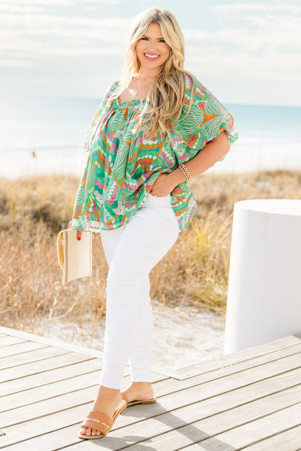 Chic Soul plus size clothing, short sleeve green tropical multicolored abstract print top with v neckline and smock detail on chest with flowy flutter sleeves