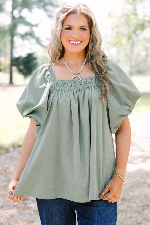 Plus size olive corduroy blouse with puff sleeves and a flowy fit.