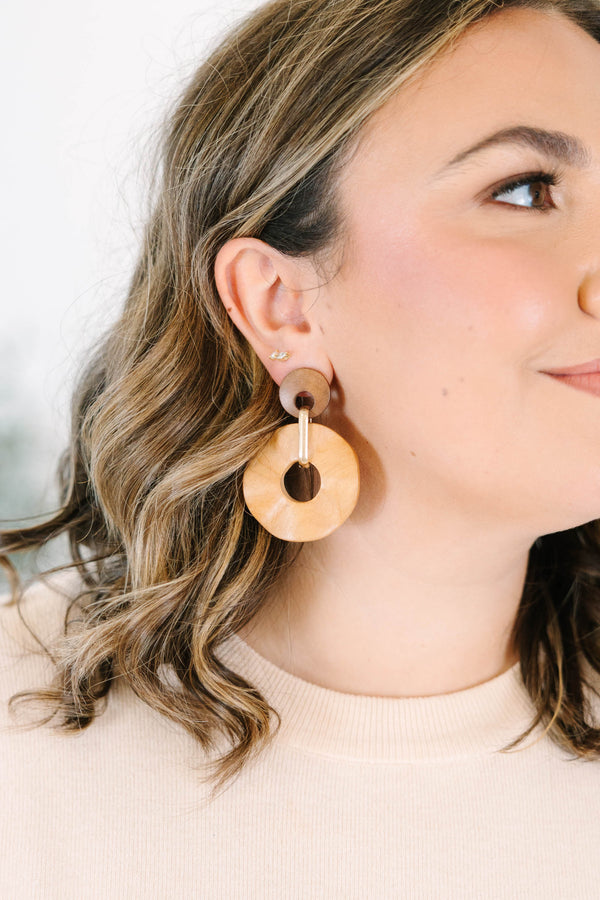 Plus Size brown wooden drop earrings featuring two circular discs connected by a gold metal link.