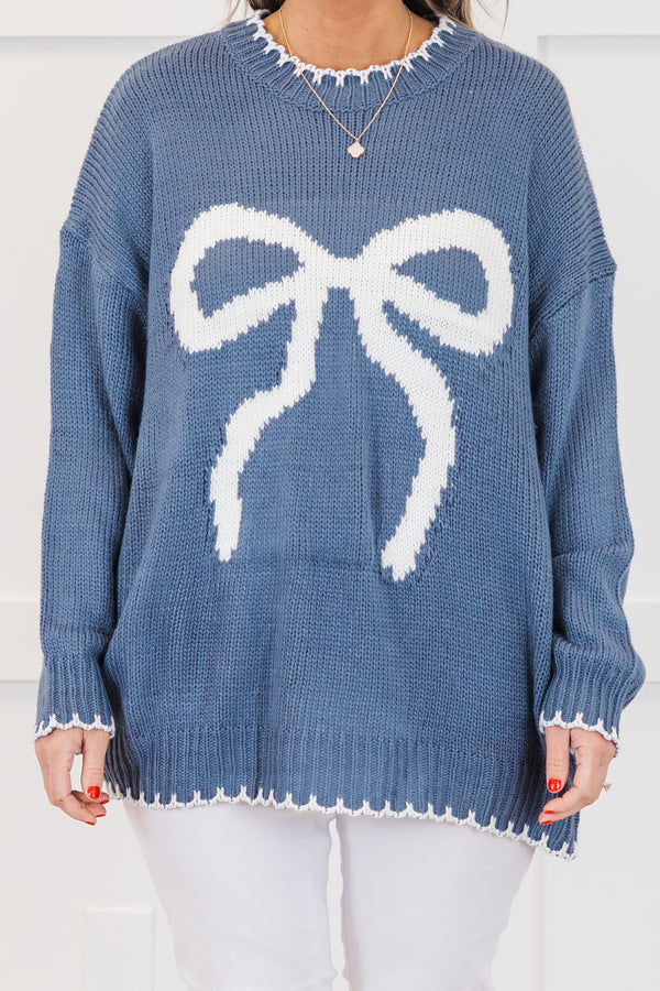 Chic Soul plus size clothing, blue long sleeve knit sweater with white bow knit design on the front with round neckline and cuff sleeves with white knit scalloped design along bottom, sleeves, and neckline