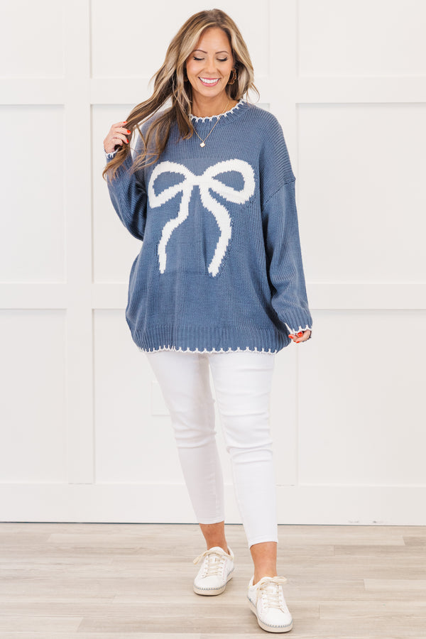 Chic Soul plus size clothing, blue long sleeve knit sweater with white bow knit design on the front with round neckline and cuff sleeves with white knit scalloped design along bottom, sleeves, and neckline