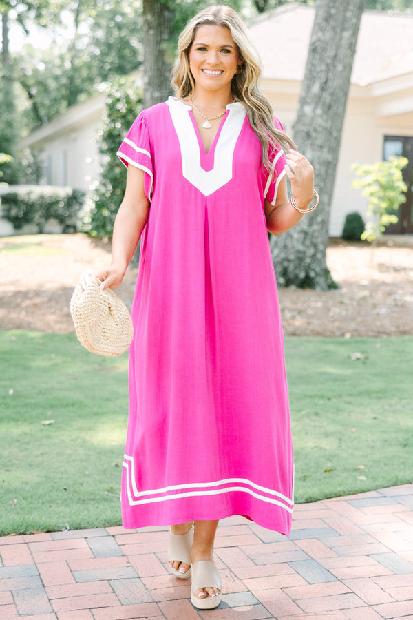 Plus size pink maxi dress with white trim, V-neckline, and flowy short sleeves.