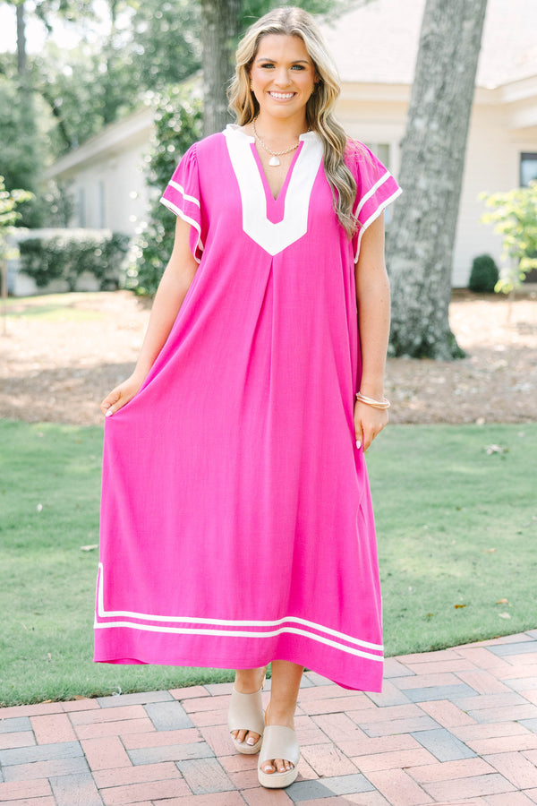 Plus size pink maxi dress with white trim, V-neckline, and flowy short sleeves.