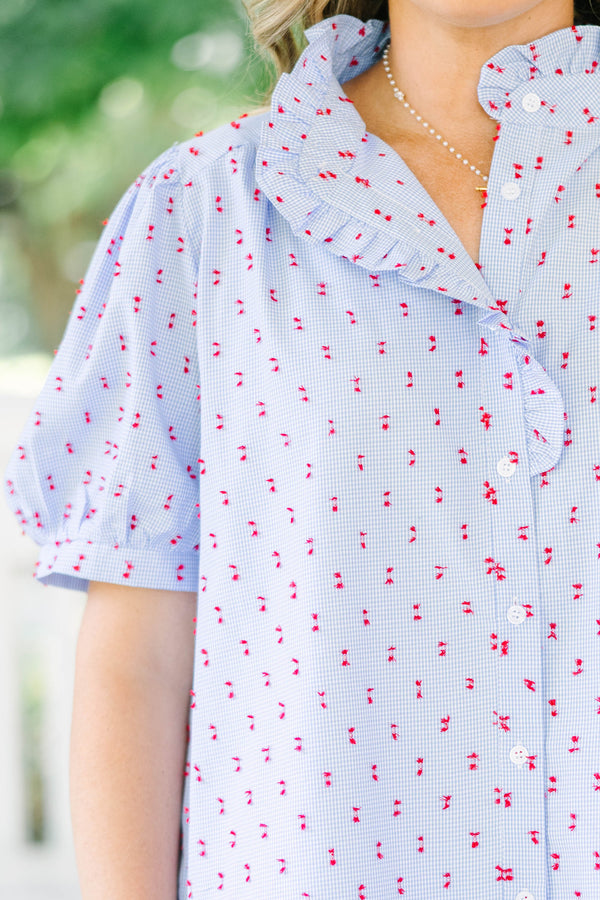 Plus Size blue gingham button-down top with red embroidery, ruffled collar, and puff sleeves.