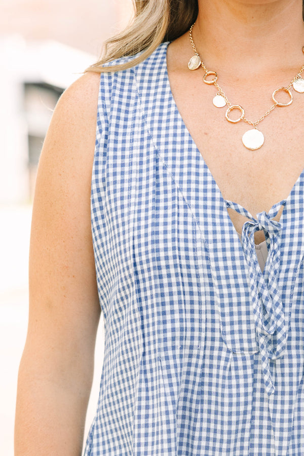 Plus Size navy and white gingham romper with a v-neckline, tie detail, and pleated design.