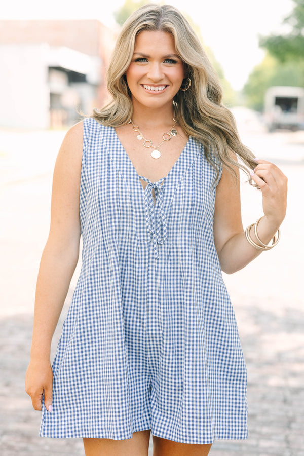 Plus Size navy and white gingham romper with a v-neckline, tie detail, and pleated design.