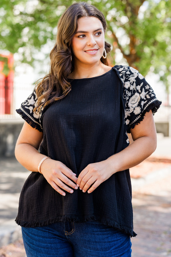 Chic Soul plus size clothing, black linen short sleeve top with round neckline and white embroidery along sleeves with raw hem detail