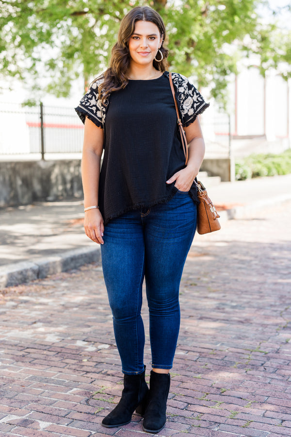 Chic Soul plus size clothing, black linen short sleeve top with round neckline and white embroidery along sleeves with raw hem detail