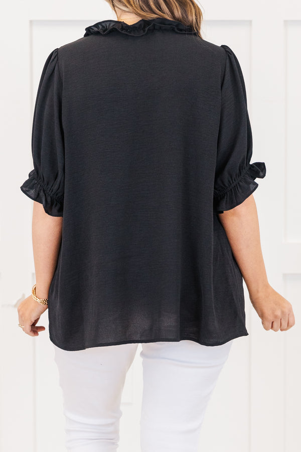 Plus Size black top with a ruffled v-neckline and elastic ruffle sleeves.
