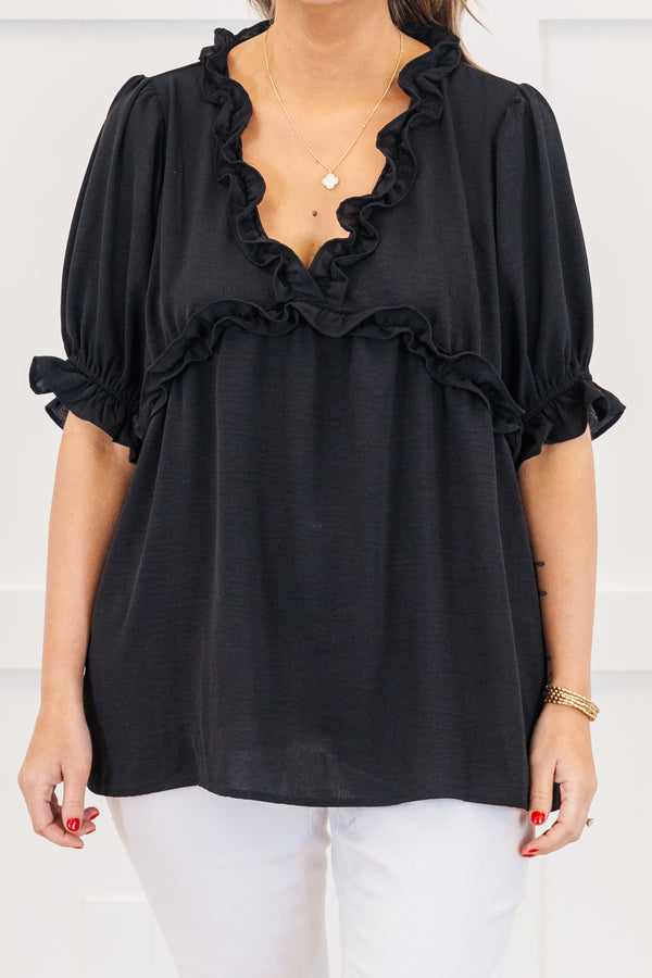 Plus Size black top with a ruffled v-neckline and elastic ruffle sleeves.